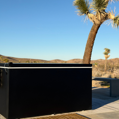 Black matte Plunge Zero HardTop cold plunge tub in a Joshua tree in a desert setting