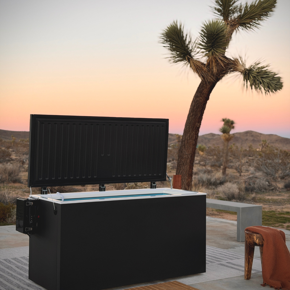 Black matte Plunge Zero HardTop cold plunge tub in a scenic desert view at sunset.