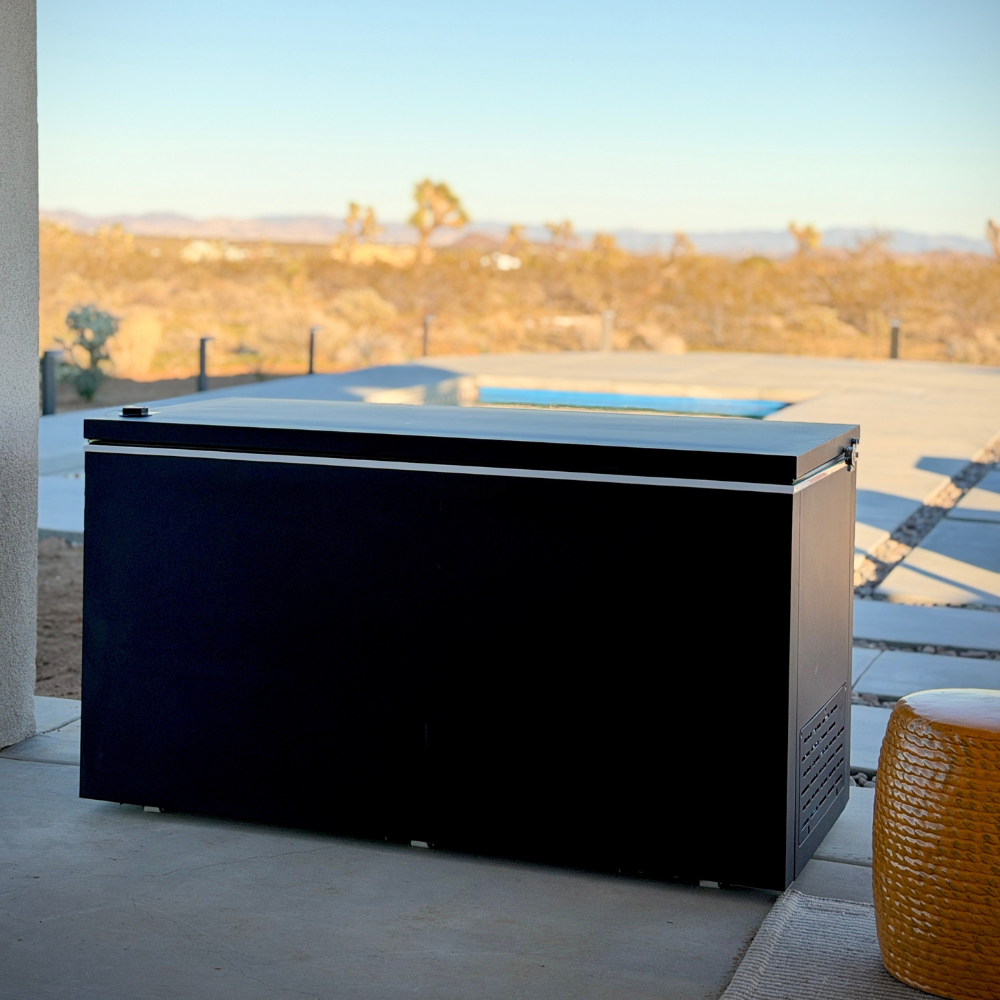 Black matte Plunge Zero HardTop cold plunge tub on a patio with a scenic background