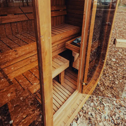 Fully assembled Mande Spa USA MW12 outdoor sauna with electric heater, open glass door, and comfortable interior view on a wooden floor for backyard wellness and home spa use.