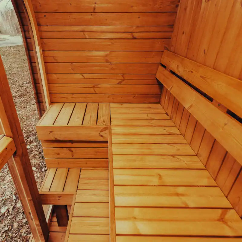 Fully assembled Mande Spa USA MW12 outdoor sauna with warm natural wood interior, and wooden bench inside the sauna.
