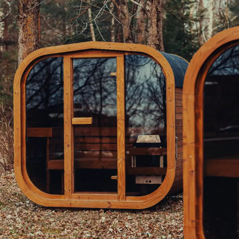 Fully assembled Mande Spa USA MW16 outdoor sauna with electric heater, and tempered glass door, windows featuring a ThermoWood® design for backyard wellness and home spa use.