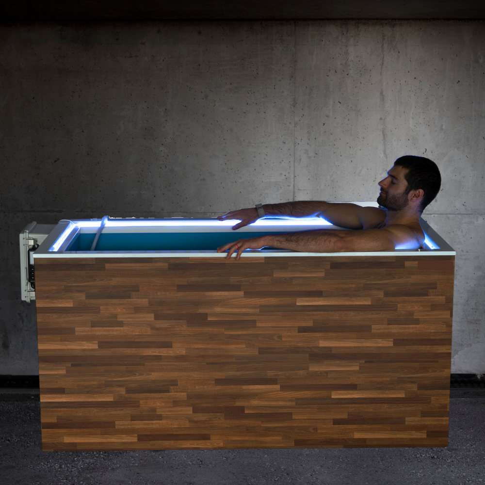 Man relaxing in a wooden hot tub with glowing interior