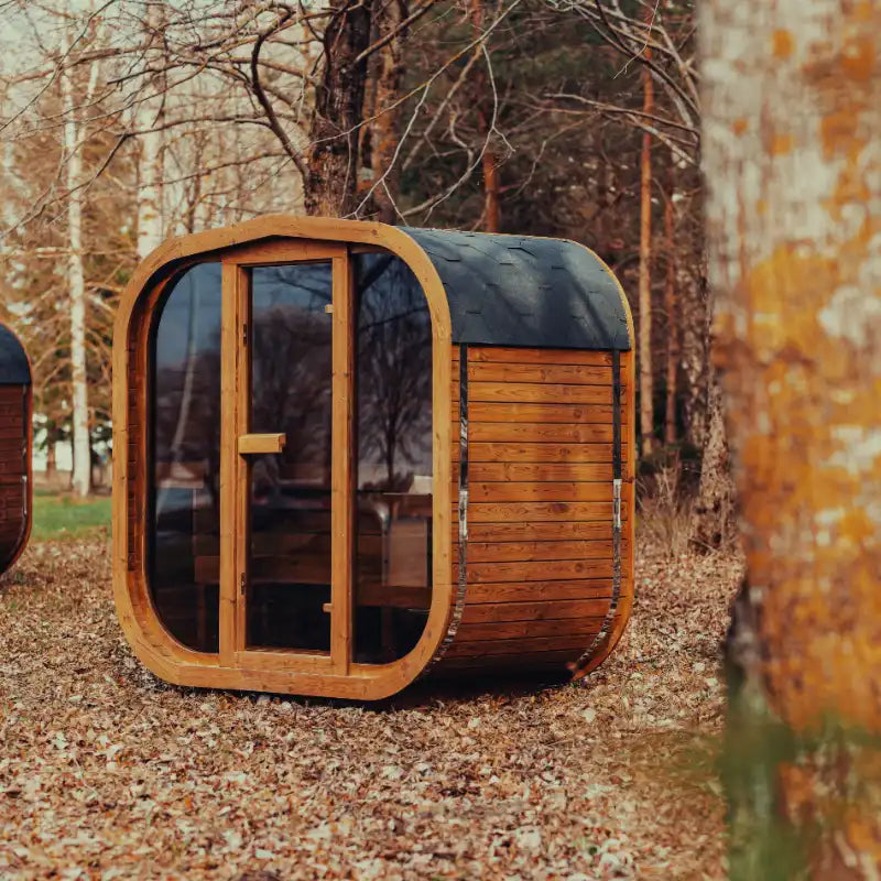Mande Spa USA MW12 outdoor sauna with Bituminous roof in a peaceful forest setting, featuring a compact ThermoWood® design for backyard wellness and home spa use.