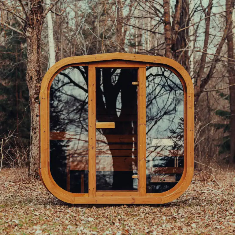 Mande Spa USA MW16 outdoor sauna with electric heater, tempered glass door, windows, bituminous roof tiles in a peaceful forest setting.
