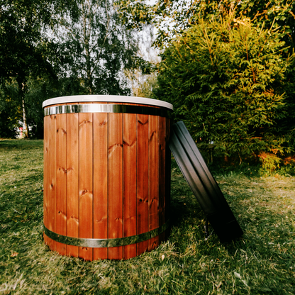 Wooden hot tub on grass with trees in the background