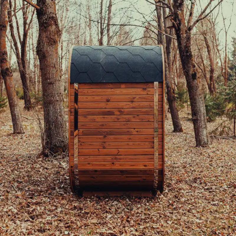 Side view of the Mande Spa USA MW12 outdoor sauna with Bituminous roof tiles in a peaceful forest setting.
