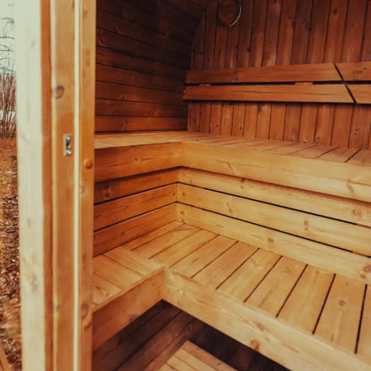 The view from outside of assembled Mande Spa USA MW16 sauna interior with benches and warm lighting, creating a relaxing home spa atmosphere.